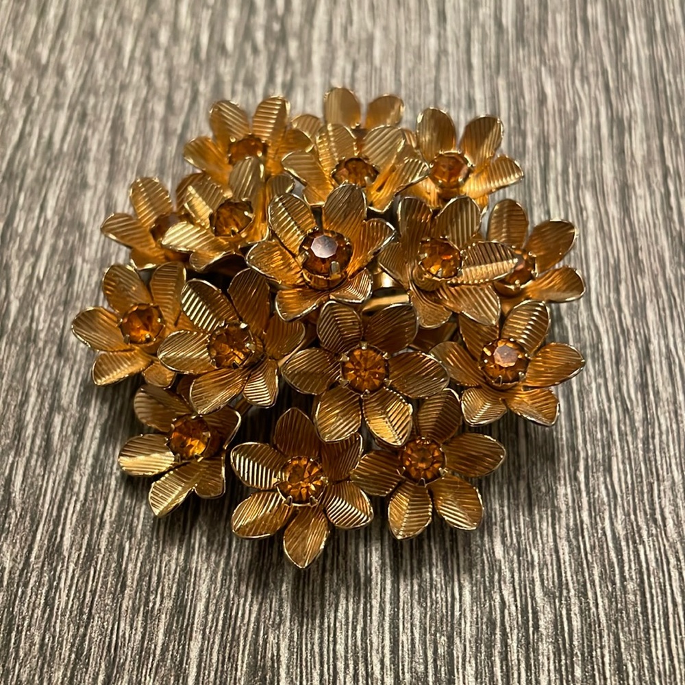 Gold colored brooch
